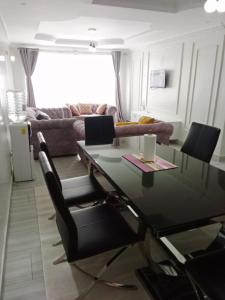 a living room with a glass table and chairs at D&H Homes Milimani Nakuru-Elegant 2 Bedroom Apartment in Nakuru