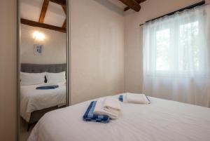 a bedroom with two beds and a mirror at South Estate in Čilipi +33 photos