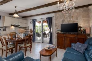 a living room with a blue couch and a table at South Estate in Čilipi