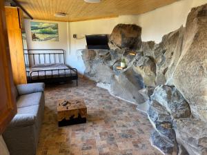 a living room with a large rock wall at Casa Roca in Arona +8 photos