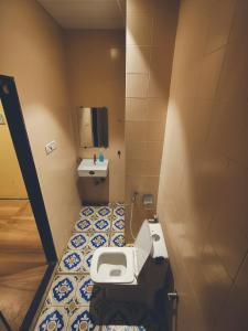 a small bathroom with a toilet and a sink at Villa 04 in Mumbai
