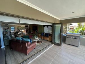 a living room with a couch and a table at Chasing Jacuzzi Sunsets sea and mountain views in Hermanus