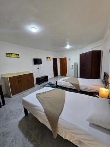 a hotel room with two beds and a television at Soltan palace in Qaryat Wādī ‘Abbādī 1 +65 photos