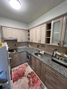 a kitchen with a sink and a counter top at Soltan palace in Qaryat Wādī ‘Abbādī 1