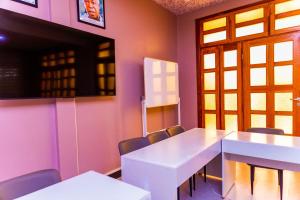 a meeting room with a white table and chairs at Grace villa in Zame