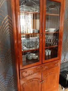 a wooden cabinet with glasses in it at Villa Gast Haus in Tsaghkadzor