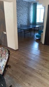 a living room with a ping pong table and chairs at Villa Gast Haus in Tsaghkadzor