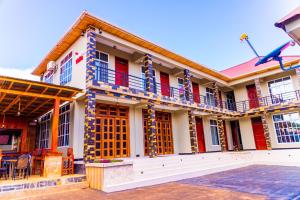 a building with red doors and a balcony at Grace villa in Zame