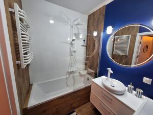a bathroom with a tub and a sink and a mirror at U Rudobrodego in Pogórze +25 photos