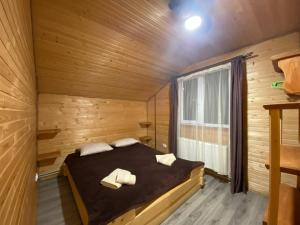 a bedroom with a bed in a wooden cabin at Шпінь 2 in Vorokhta
