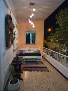 a porch with a couch and a table on a balcony at Nomads Hostel Sousse in Sousse