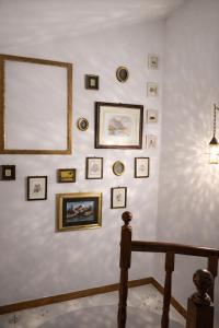 a white wall with framed pictures on it at B&B Il Fiore nel Bosco in Orte +14 photos
