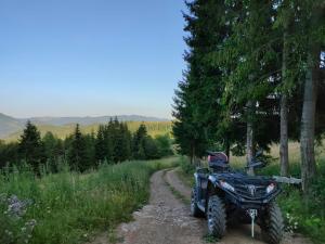 a four wheeler parked on a dirt road at Pensiunea Bucur in Dămuc
