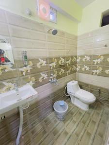 a bathroom with a sink and a toilet and a sink at The Cruze - Premium Hotel in Gulzārbāgh