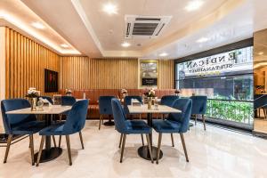 a restaurant with two tables and blue chairs at Sultanahmet Newport Hotel in Istanbul