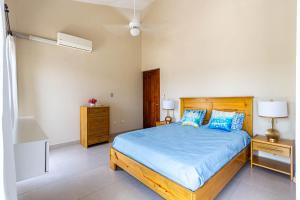 a bedroom with a bed with blue sheets and blue pillows at Novus Mare, Cabarete center! in Cabarete +14 photos