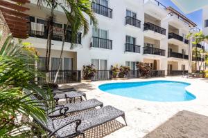 an apartment with a swimming pool in front of a building at Novus Mare, Cabarete center! in Cabarete