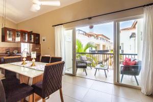 a kitchen and dining room with a table and a balcony at Novus Mare, Cabarete center! in Cabarete