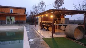 a house with a pavilion next to a swimming pool at Appartamento relax 5-4-3 in Rivalta Bormida