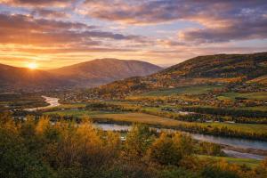 a view of a valley with a river and mountains at Traditional timber farm with Sauna & Wi-Fi in Baukål