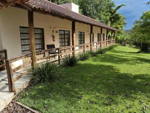 a house with a wooden fence in the yard at Park Golf Hostel Ipelandia in Foz do Iguaçu