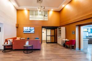a lobby of a hospital with a couch and chairs at Comfort Suites in London