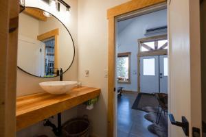 a bathroom with a sink and a mirror at Anasazi Cliffs Lodging in Apple Valley +98 photos
