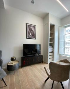 a living room with a chair and a table at San VICENTE in Vigo