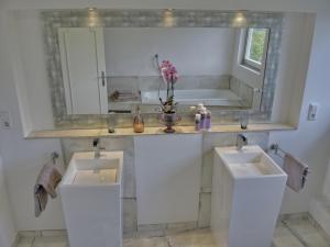 a bathroom with two sinks and a mirror at Rheinvilla Weitblick in Boppard +25 photos