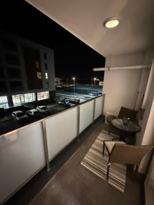 a balcony with a view of a parking lot at night at Luxury Residence in Baia Mare