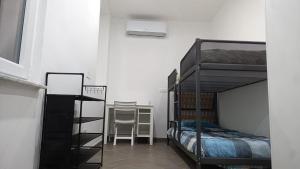 a bedroom with two bunk beds and a desk at Appartamento relax 5-4-3 in Rivalta Bormida +33 photos