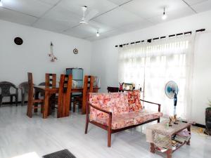 a living room with a couch and a table at Vinal Inn Midigama in Midigama East