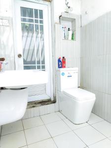 a bathroom with a toilet and a sink at Vinal Inn Midigama in Midigama East +12 photos