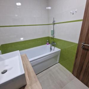 a bathroom with a white tub and a sink at Viilor Panoramic in Baia Mare +19 photos