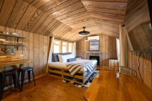 a bedroom with a bed and a wooden ceiling at Anasazi Cliffs Lodging in Apple Valley
