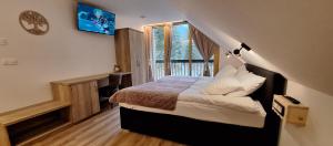 a bedroom with a bed in a room with a window at Gostišče Jezersko in Zgornje Jezersko +36 photos