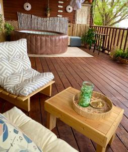a patio with a wooden deck with a table and chairs at Boho B&B in Amnon +53 photos