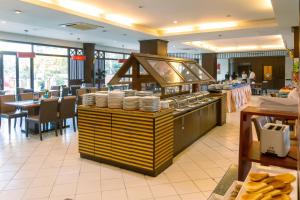 a restaurant with a counter with plates on it at Mountain Beach Resort & Convention Center in Pattaya South
