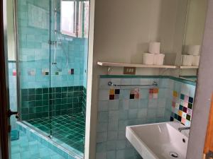 a bathroom with a glass shower and a sink at La Casa Di Cosimo Guest House in San Piero a Sieve