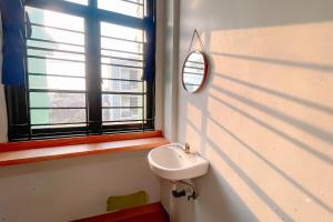 a bathroom with a sink and a mirror on the wall at Staigo at SG Premium in Medan