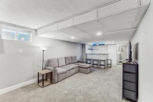 a living room with a couch and a kitchen at Group-Friendly Michigan City Home Near Beach! in Michigan City