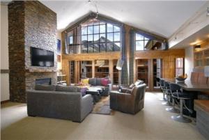 a large living room with couches and a bar at The Lodge at Mountaineer Square, A Vail Resorts Property in Mount Crested Butte
