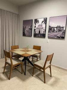 a dining room with a wooden table and chairs at Hotel Germânia Nova Veneza in Nova Veneza