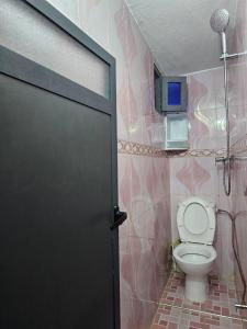 a bathroom with a toilet and a door in it at ADAGHAS studio 1,3 in Agadir +17 photos