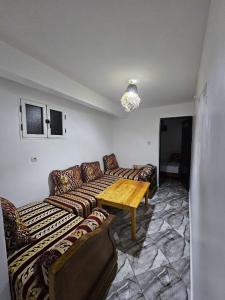 a living room with couches and a wooden table at ADAGHAS studio 1,3 in Agadir