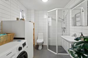 a bathroom with a shower and a sink and a toilet at Harmony apartments - Stavanger sentrum in Stavanger