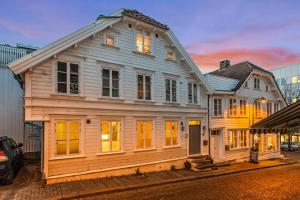 a large wooden house sitting on the side of a street at Harmony apartments - Stavanger sentrum in Stavanger