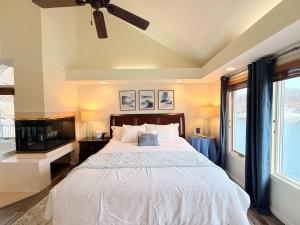 a bedroom with a bed and a ceiling fan at Mimosa Mornings Home for 12 in Rocky Mount
