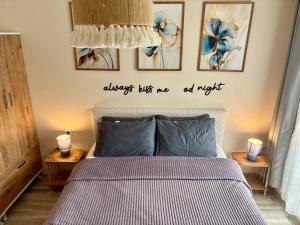 a bedroom with a bed with two candles on the wall at Theos Holiday Apartments Room 23 Family Suit Accommodation For Families Only in Kuşadası +10 photos