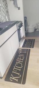 a kitchen with two kitchen mats on the floor at Lace Luxe Homes in Tatu City